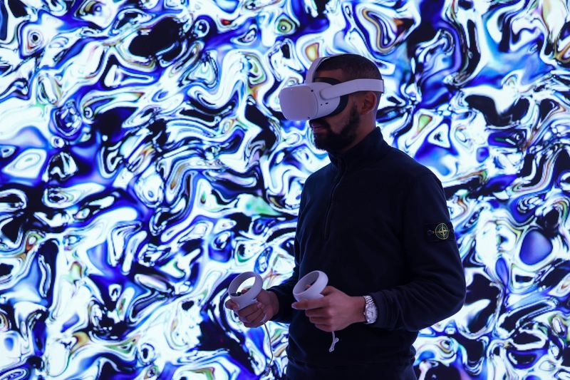 Meta headset with hand controllers.  Source: Bloomberg